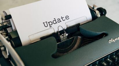 white printer paper on green typewriter