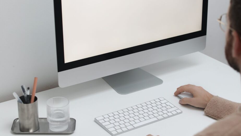 Free Crop man working on computer in workplace Stock Photo