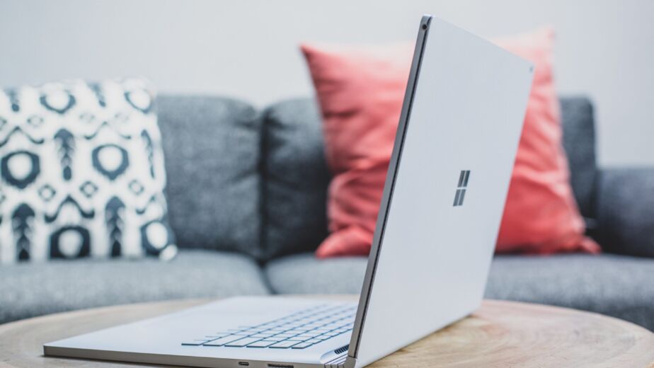 macbook pro on white couch