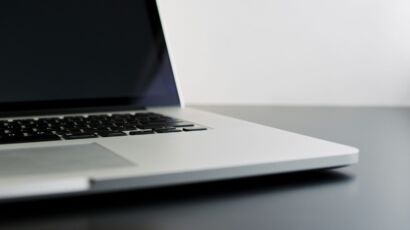 silver laptop computer on black table