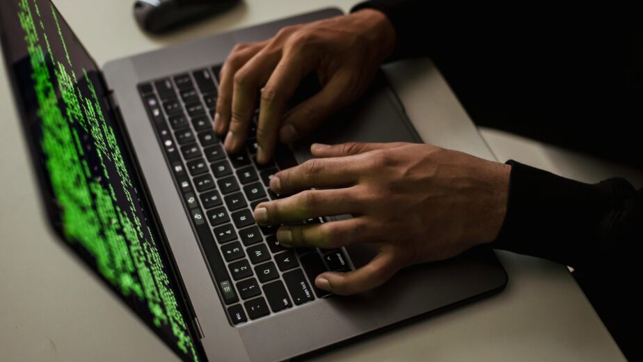 crop-cyber-spy-hacking-system-while-typing-on-laptop