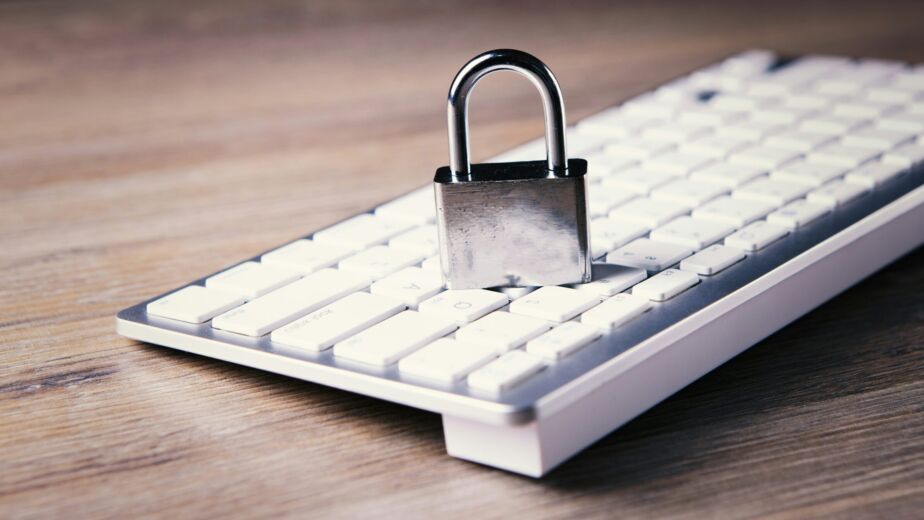 a computer keyboard with a padlock on top of it
