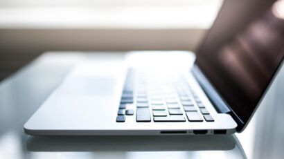 Free Elegant side view of a laptop on a glossy table with natural lighting indoors. Stock Photo